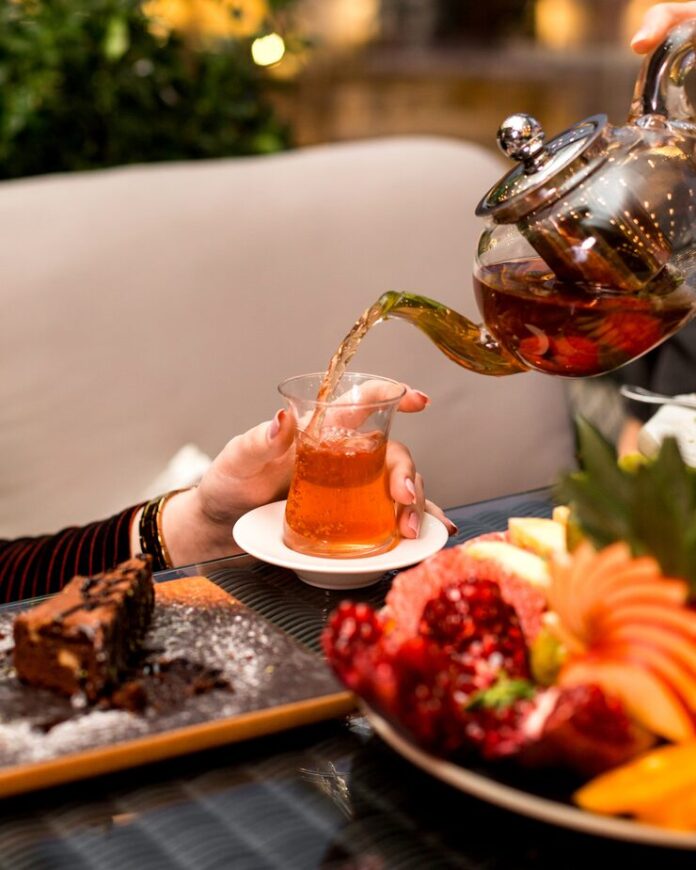 woman-pours-tea-into-armudu-glass_140725-9051